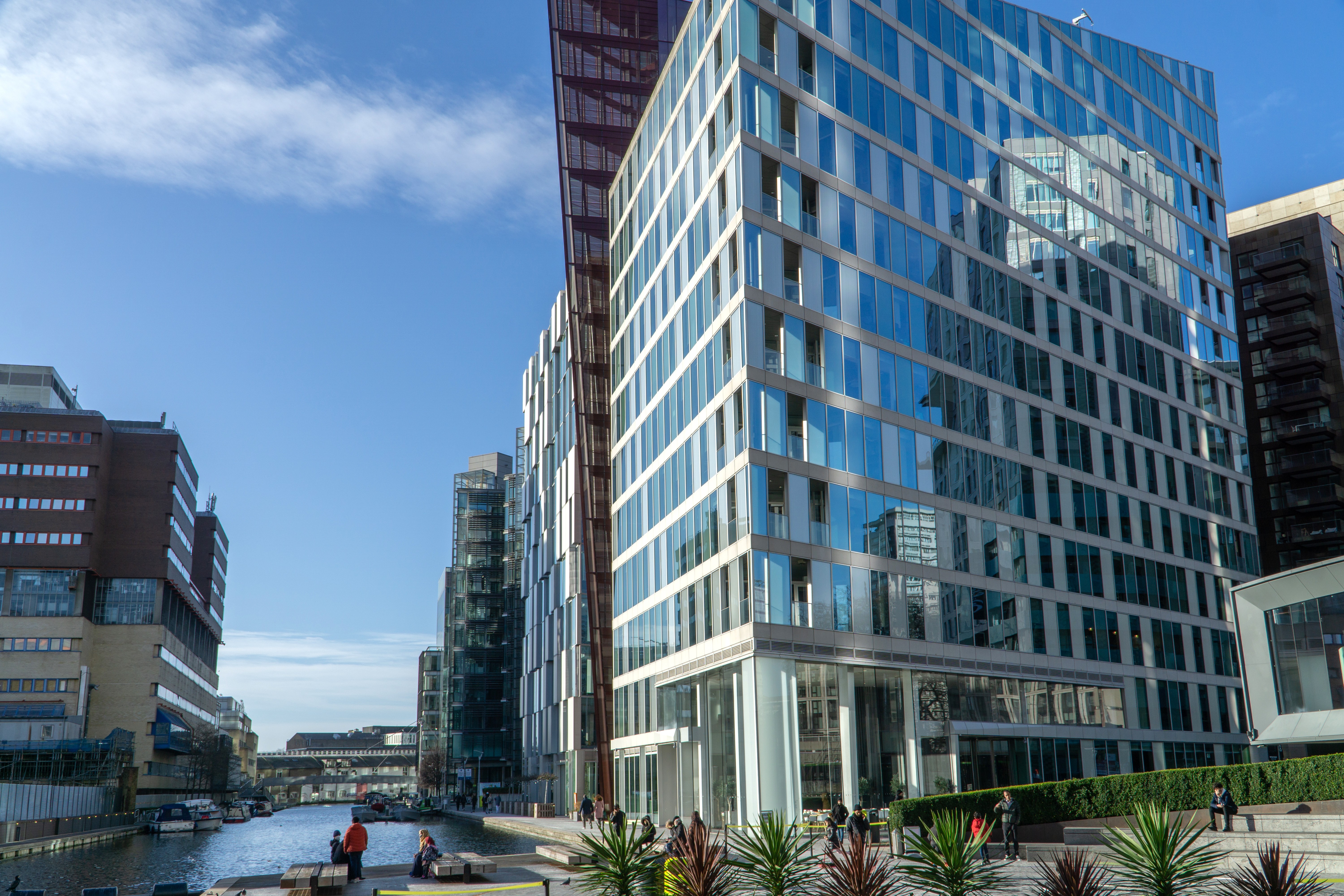 Close-up of a biometric fingerprint access control scanner on a commercial doorway.