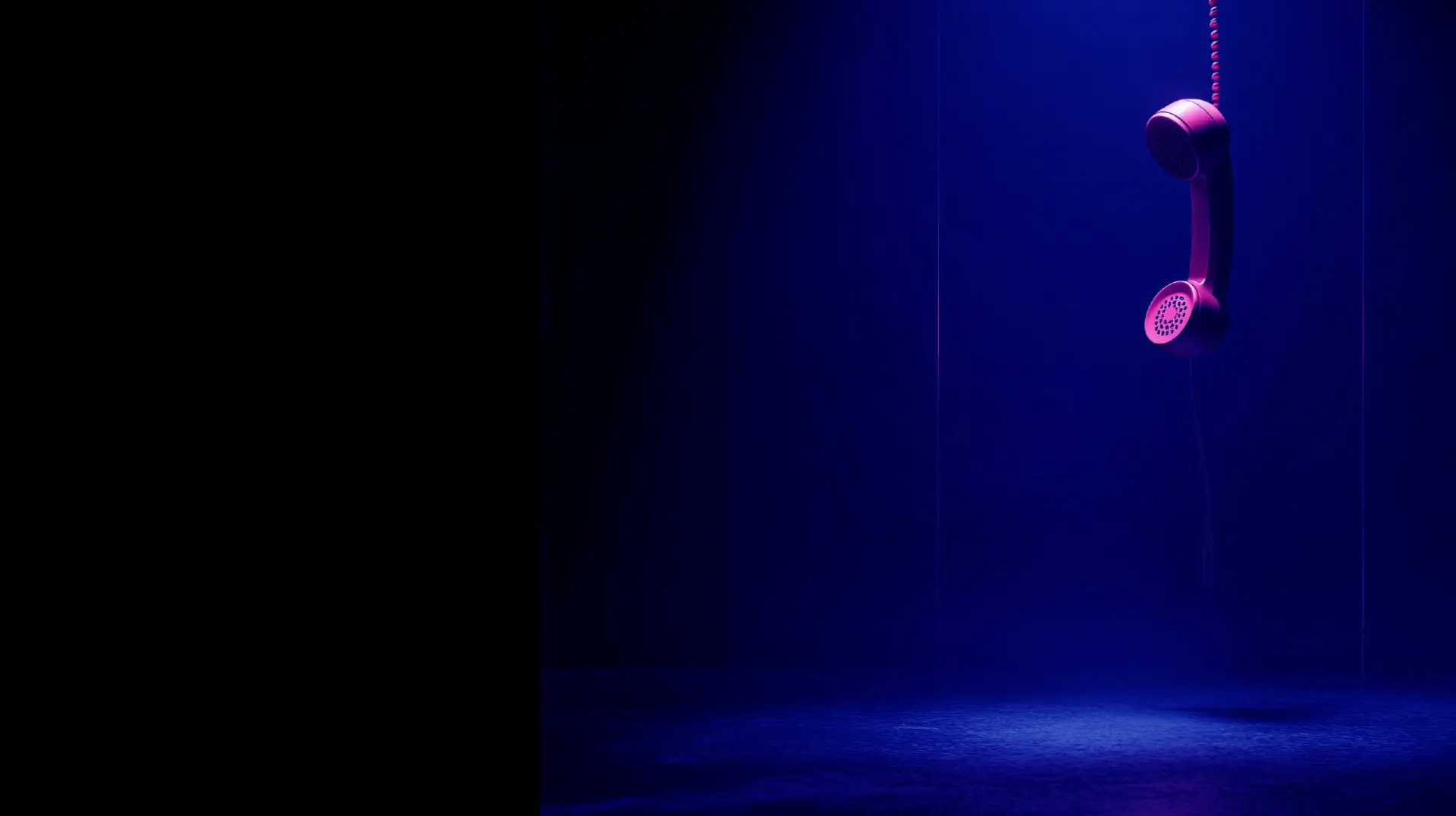 Pink telephone handset hanging from its cord in blue light