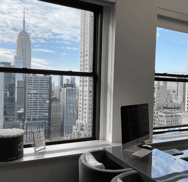 person holding black ipad with green plant