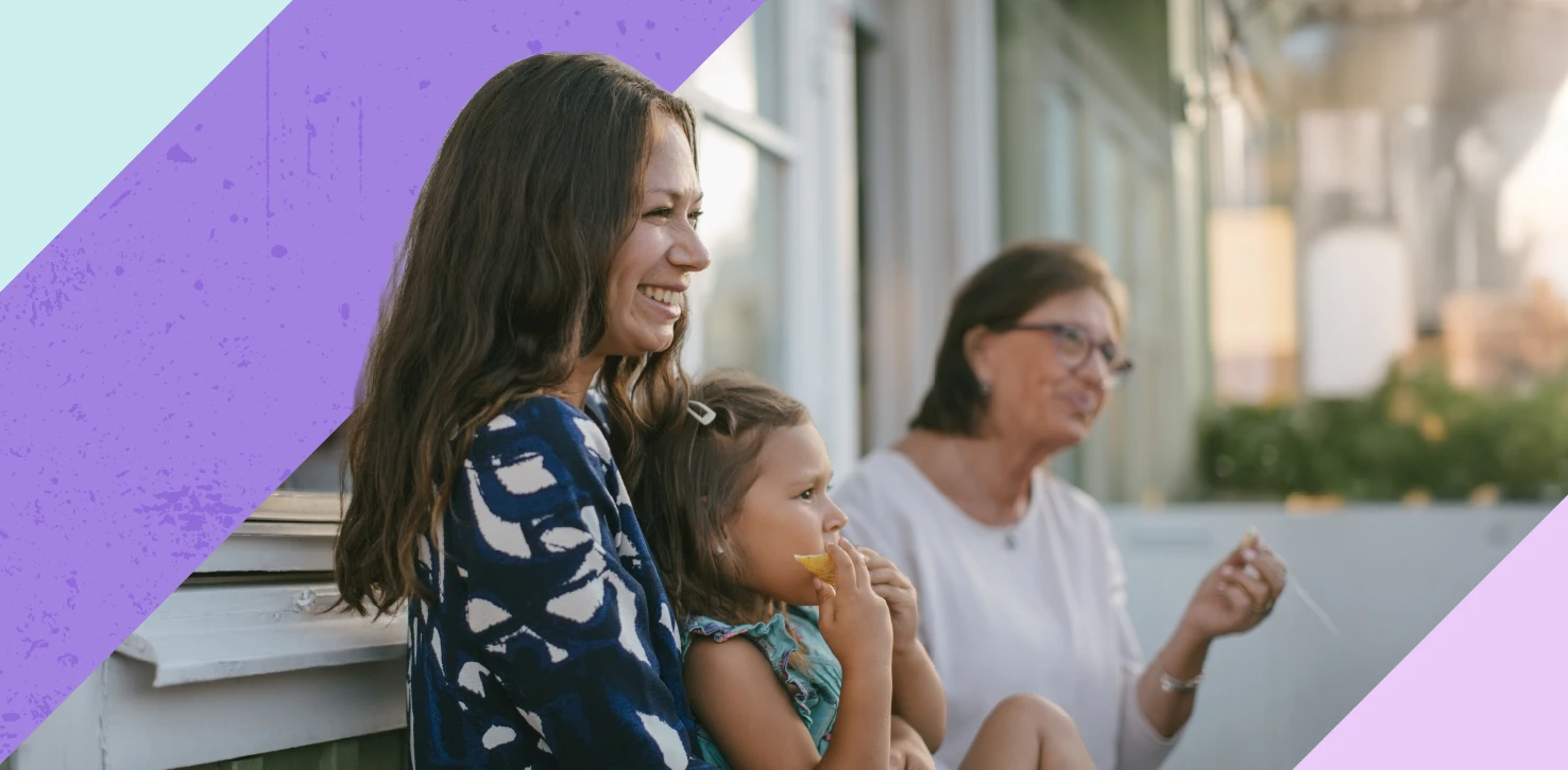 Woman holding baby smiling