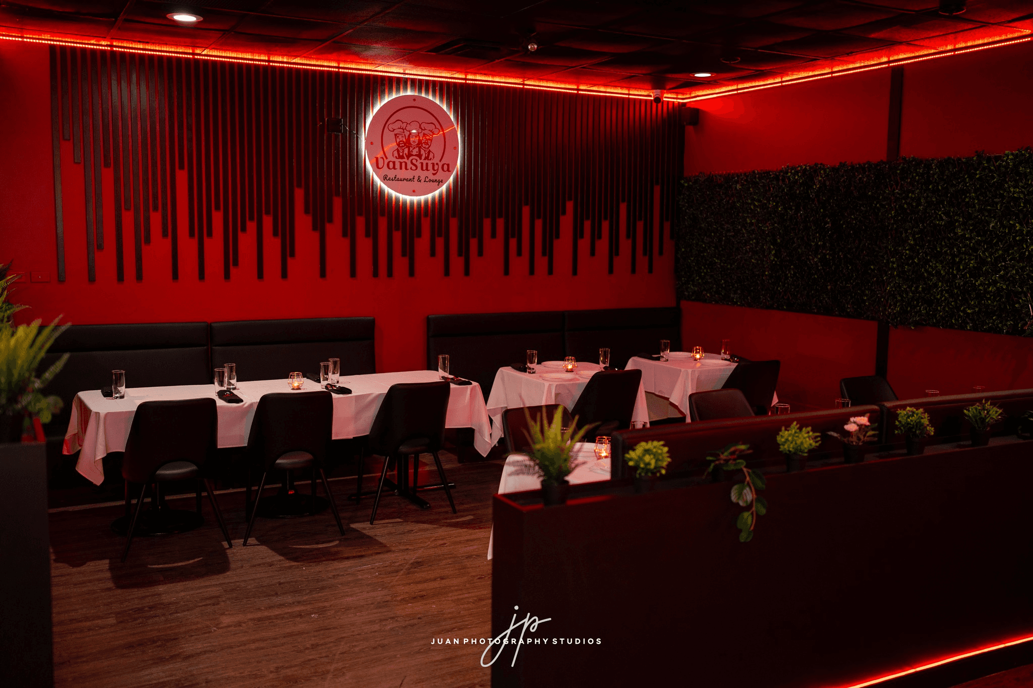 a dimly lit restaurant with orange chairs and a round table