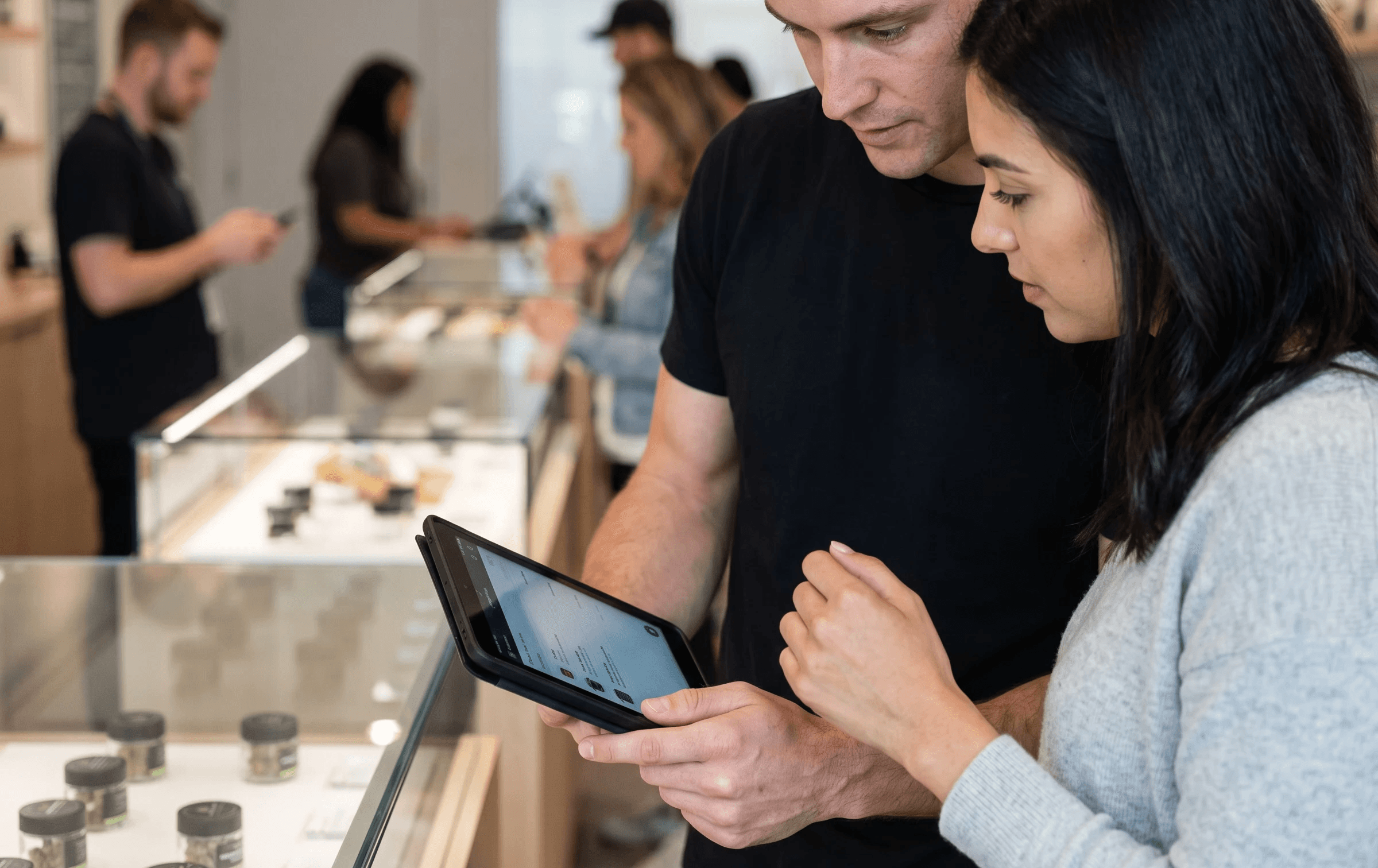 a man and a woman looking at a tablet