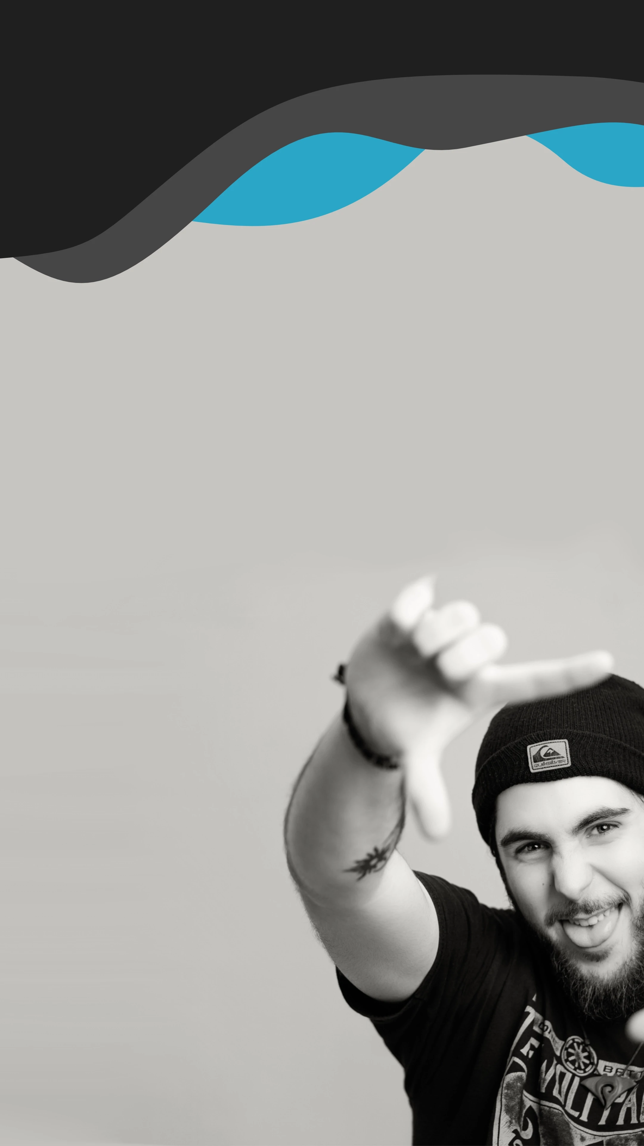 Black and white portrait of videographer framing a shot with hands against a clean background, representing creative direction, visual storytelling and professional videography by Raybrand Media