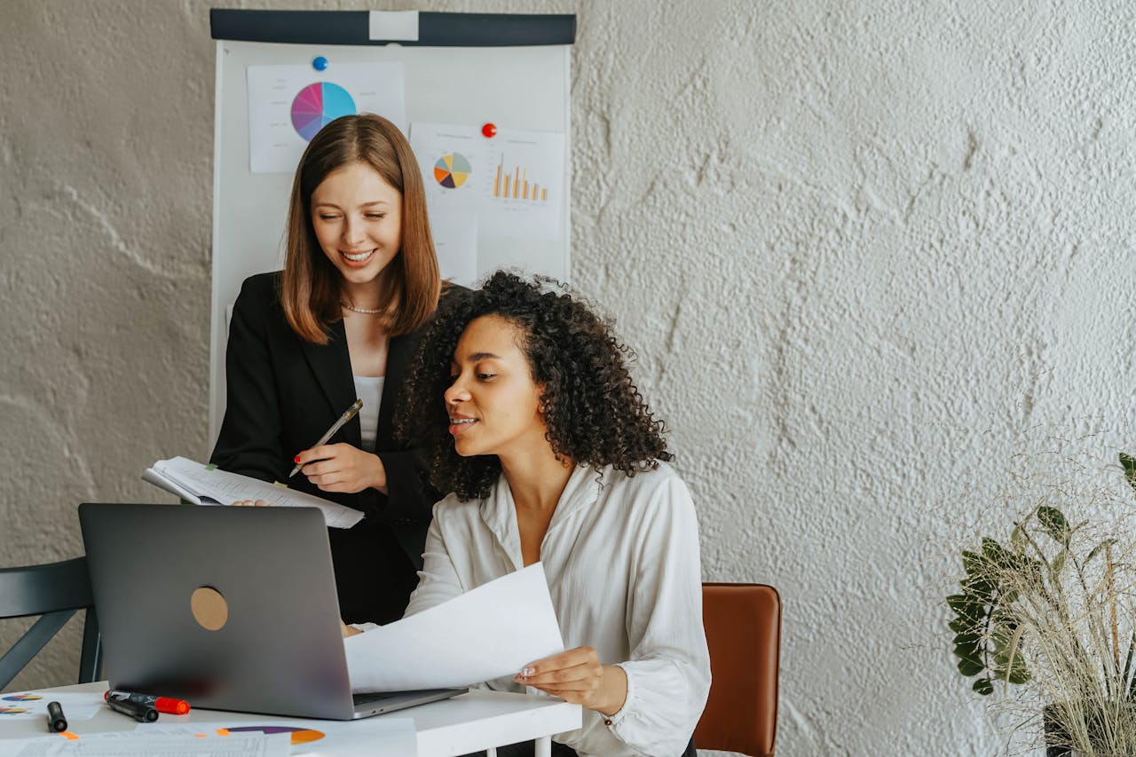 Women Sitting on a Sofa While Talking Business