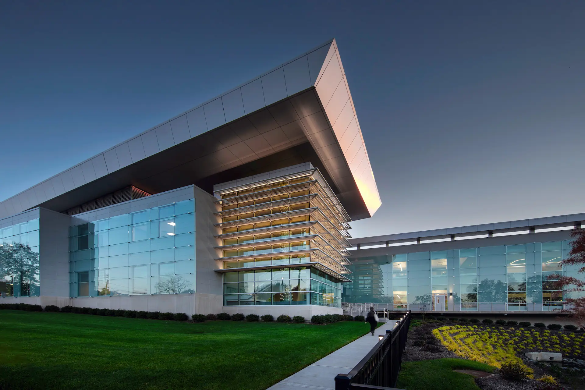 Rolled architectural blueprints with detailed floor plan drawings spread in overlapping layers.