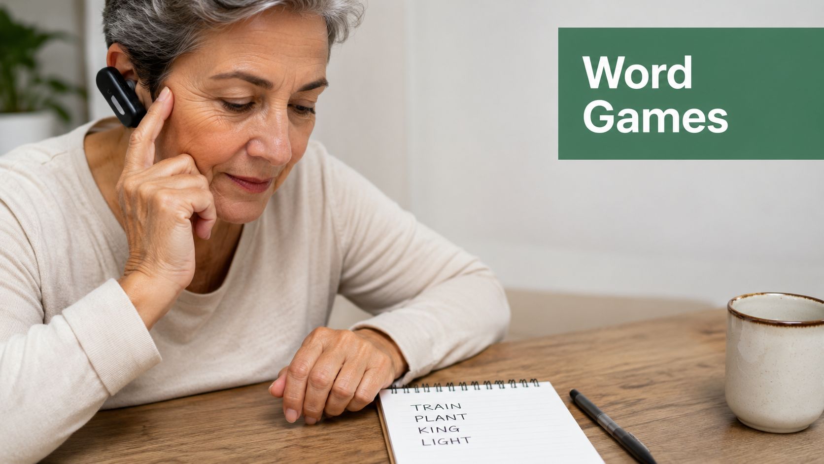 An elderly woman with a headset focuses intently while completing word games in a notebook on her desk.