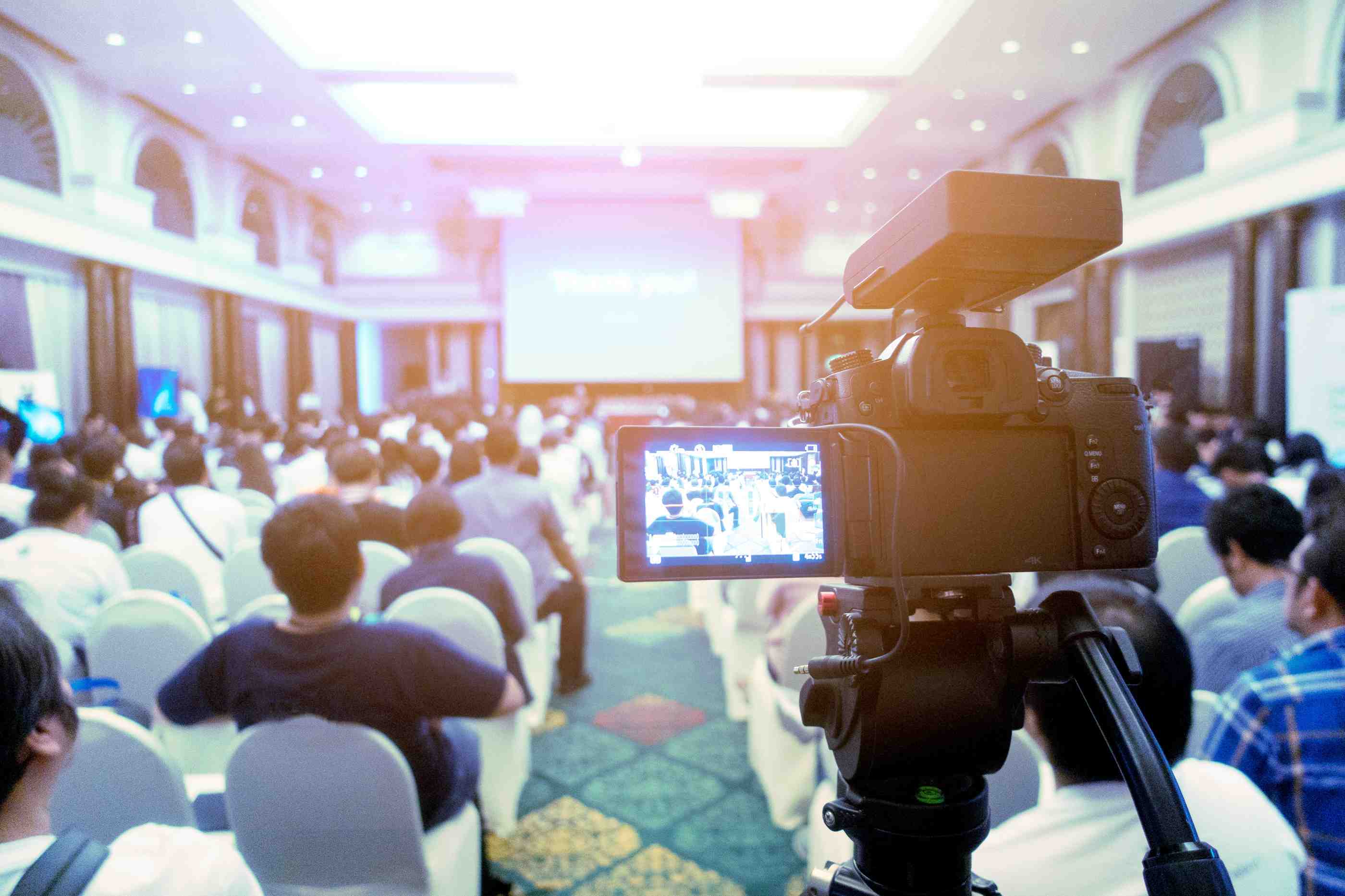  Hybrid event streaming setup capturing a live conference session with an engaged audience