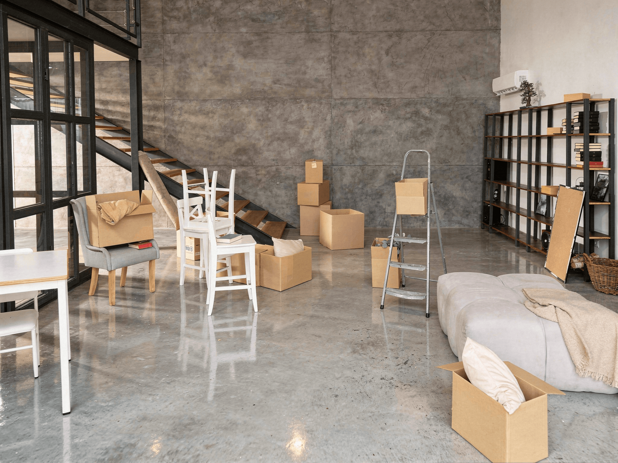 Brisbane home mid-move with boxes, ladder and furniture ready to clear the space before hybrid flooring installation.