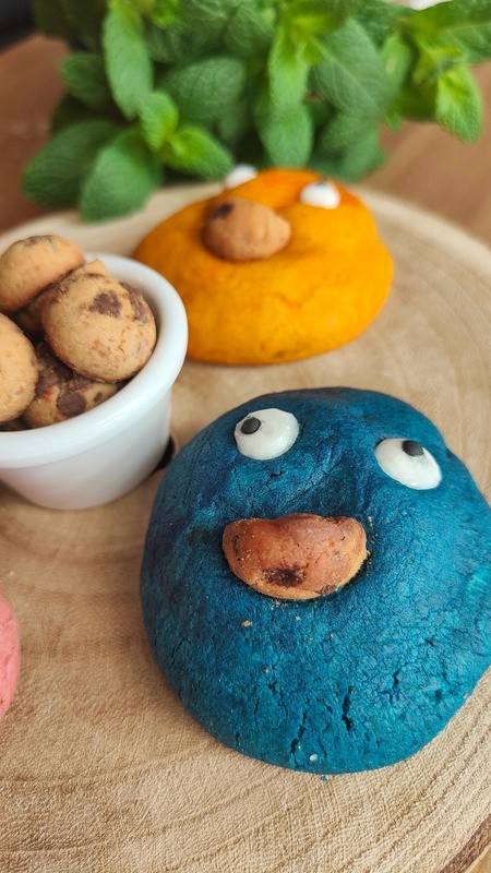 Blue monster cookie in close-up view with a chunky, baked texture