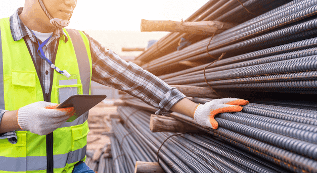 Man standing beside construction materials