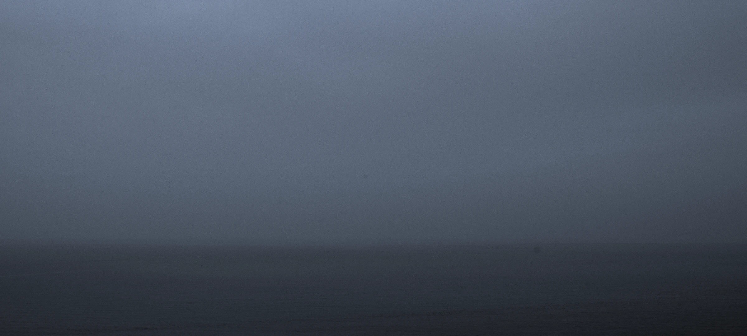 Sea horizon disappearing into fog