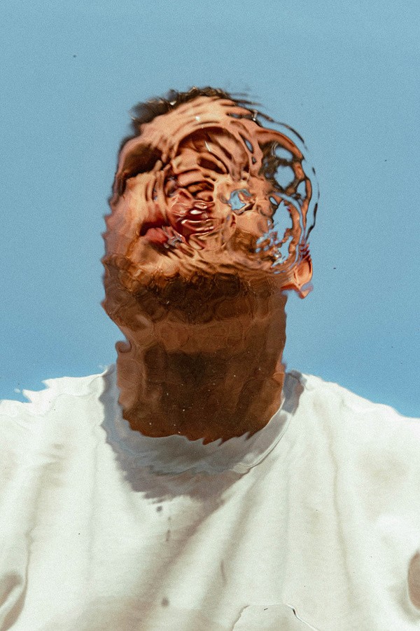 upper view of ripple image of mans face underwater