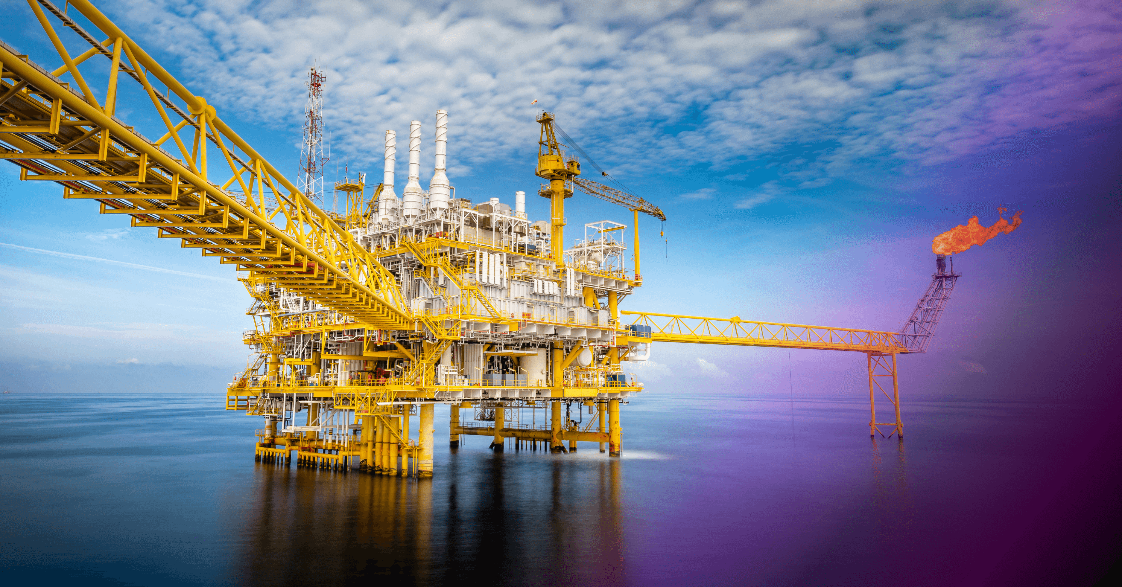 Offshore oil and gas drilling platform with a flare boom in the middle of the ocean.