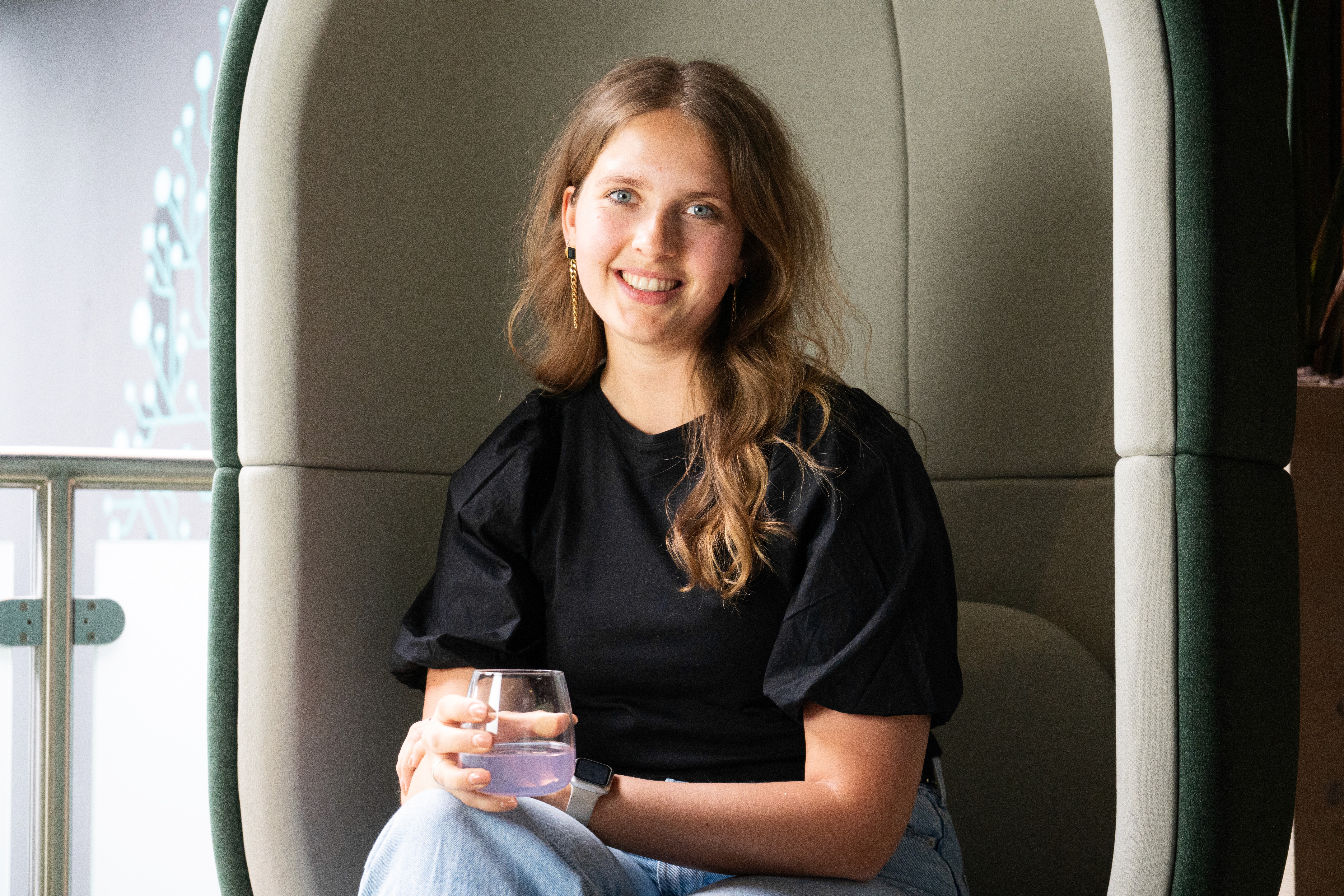4 colleagues laughing while drinking water at Infinite Group