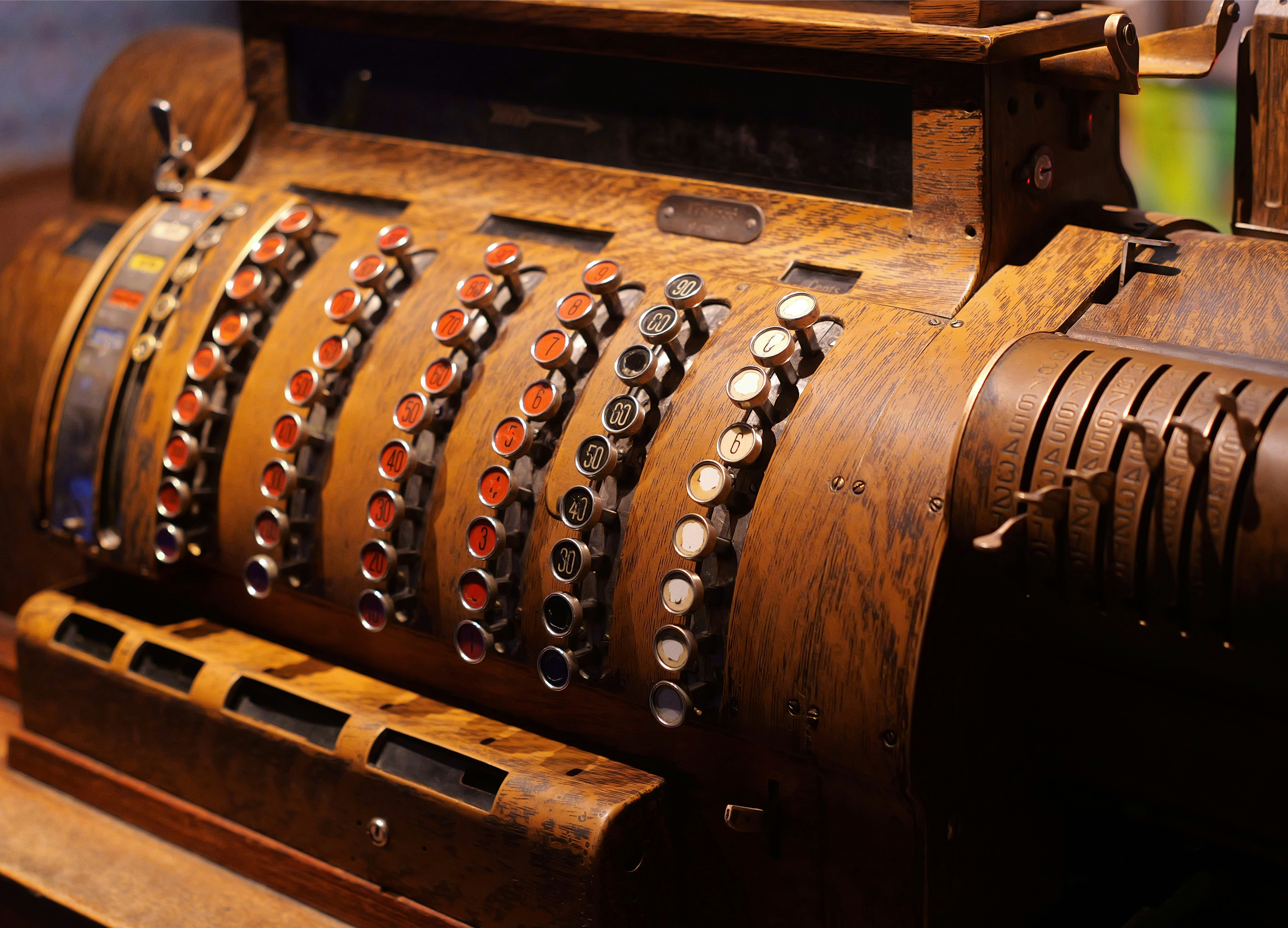 Antique cash register with detailed buttons.