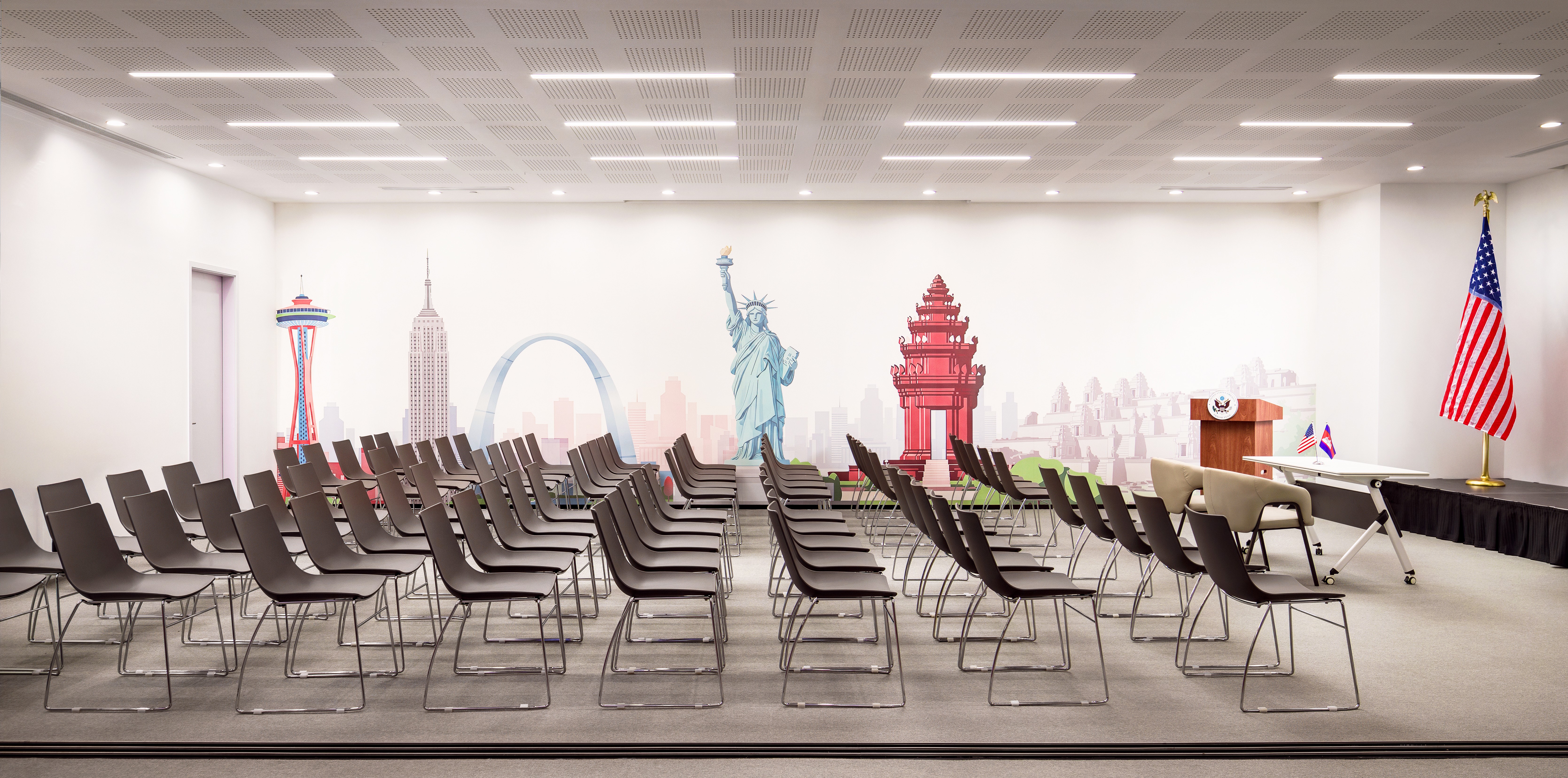 High-spec conference room featuring star-patterned acoustic wall panels and integrated A/V technology.