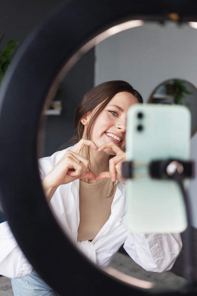 Creator using smartphone for content production with Komi platform technology