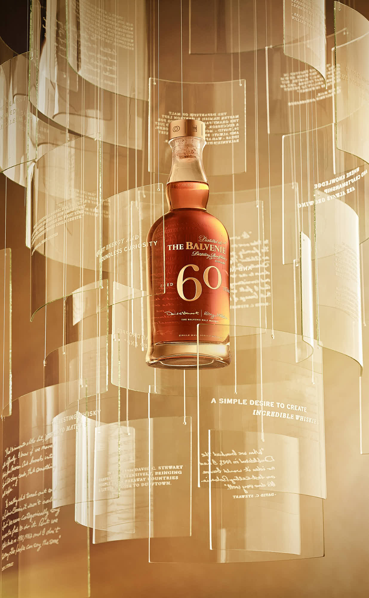 A decorative lamp hangs against a backdrop of translucent panels, casting a warm glow in the space.