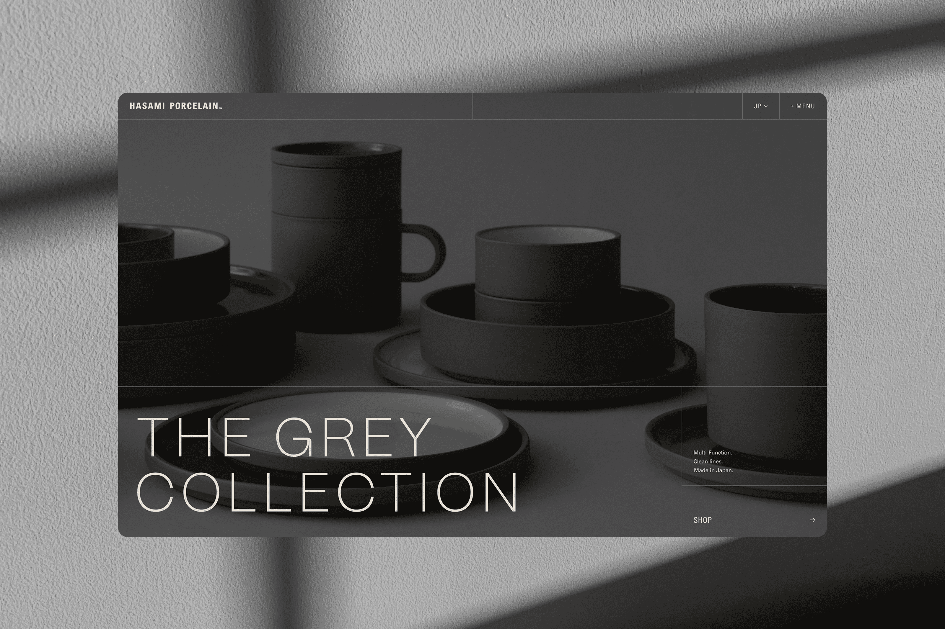 Homepage hero with the title overlaid on top of an image featuring Hasami Porcelain's new grey collection of bowls, plates, and mugs