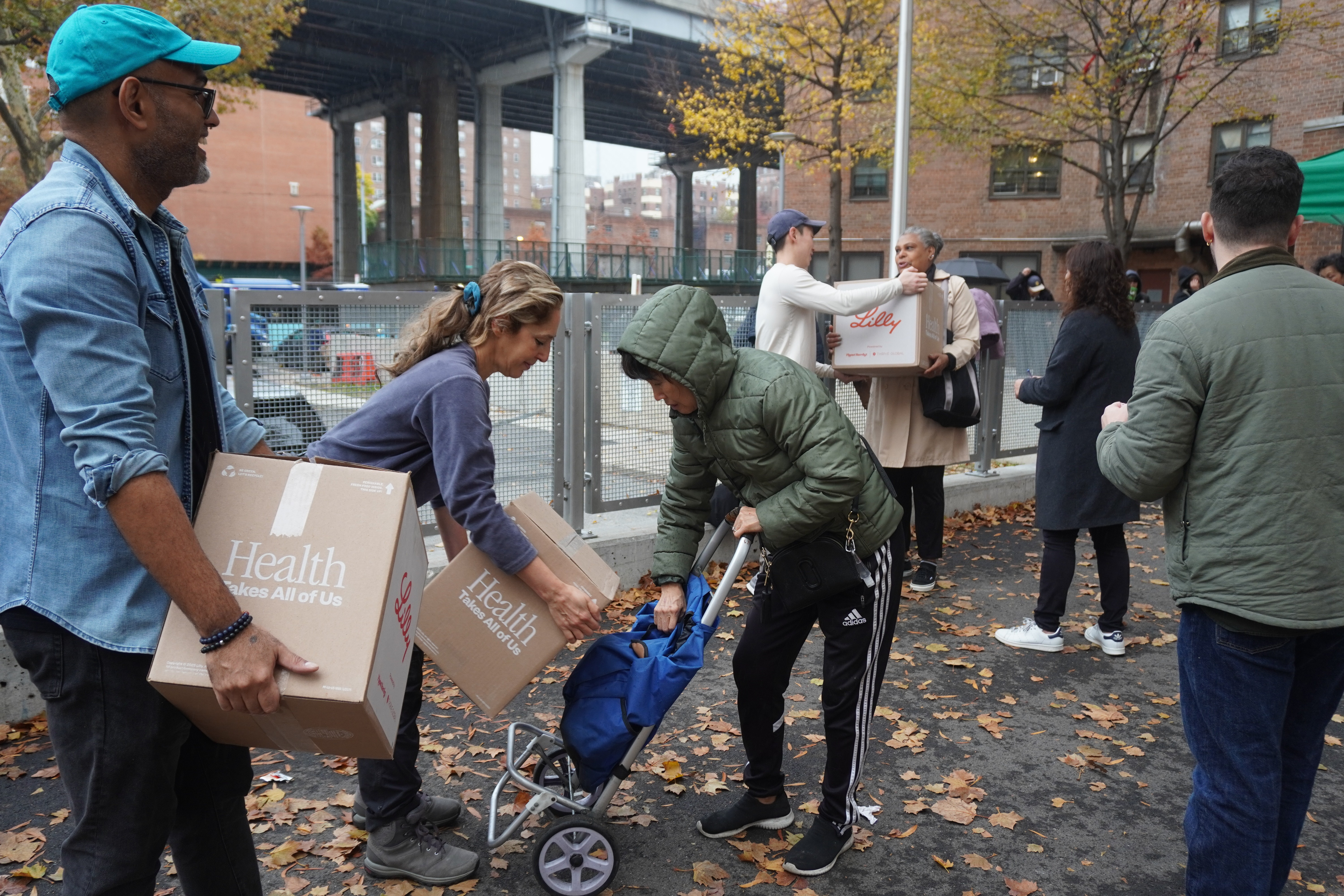 Volunteers help distribute food packages to families and individuals.