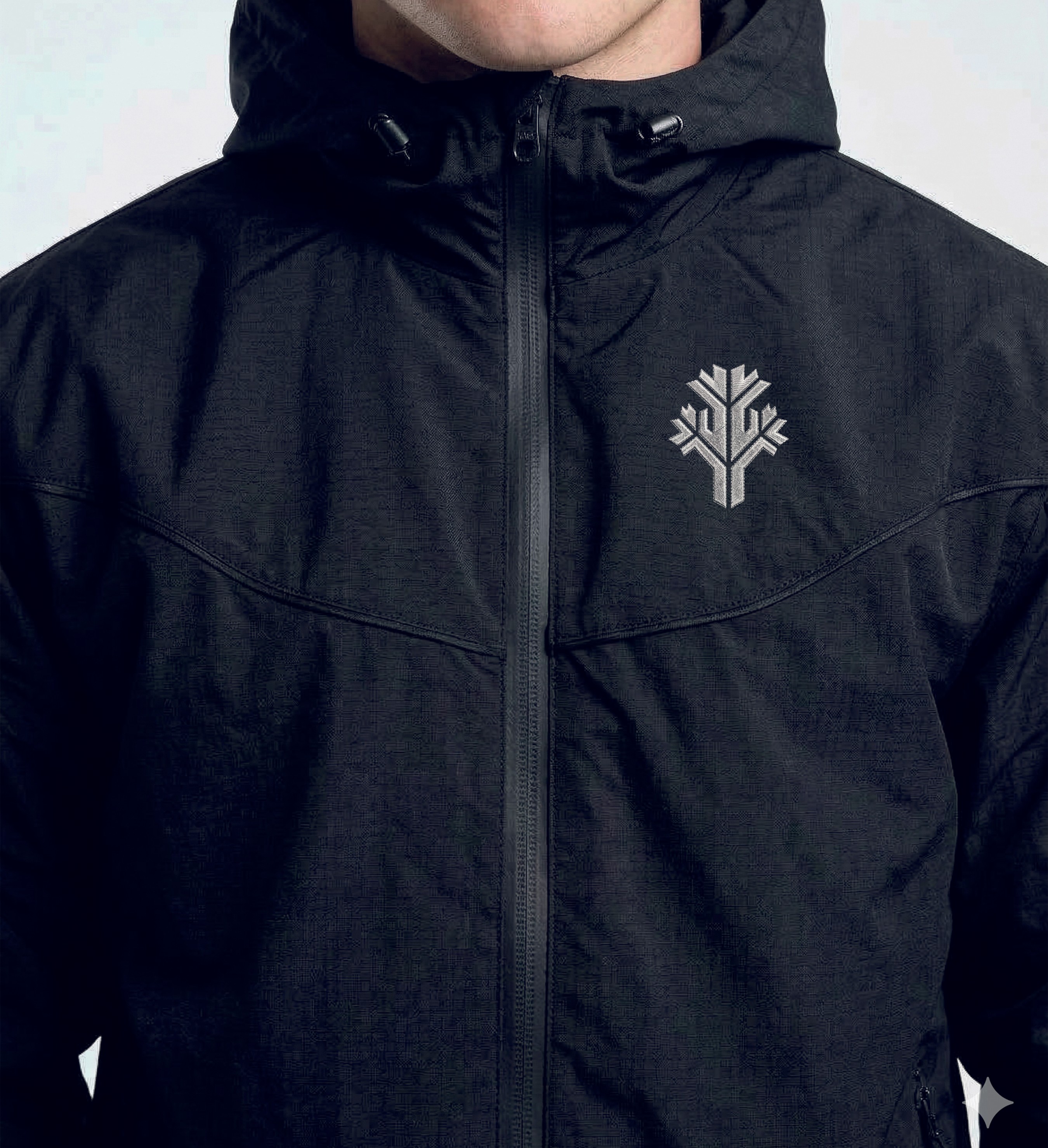 A man in a black jacket with a badge on his pocket