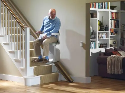 Stairlift on a carpeted staircase, installed by LiveWell