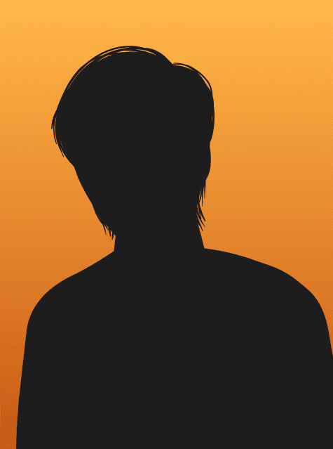 A young man in a white t-shirt stands against a light-colored background.