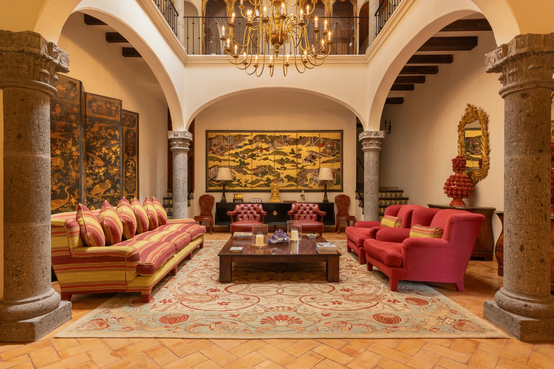 La Residencia San Miguel colonial facade with arched portico, tiled steps, and landscaped gardens