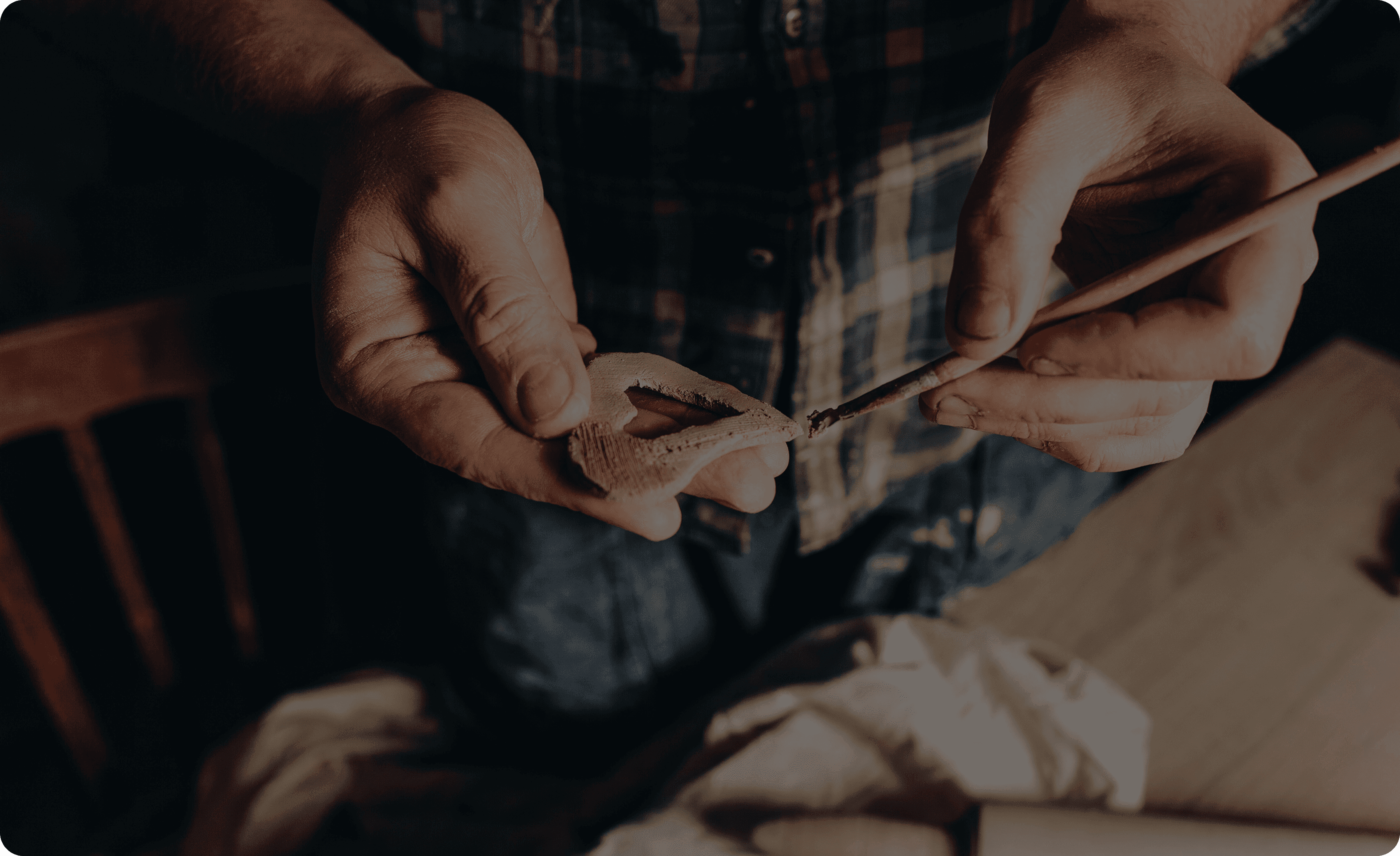 Close-up of hands wood carving, showcasing traditional wood craftsmanship.