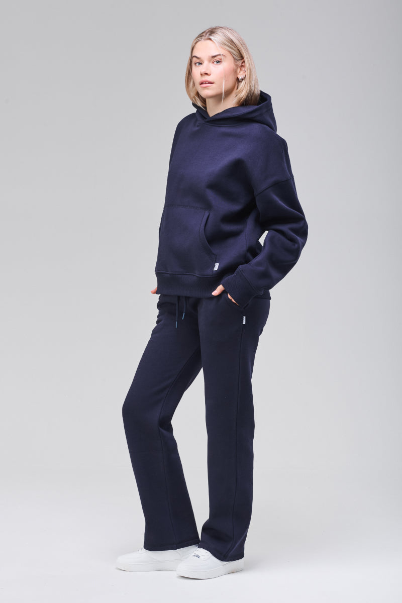Model wearing navy boxy hoodie, full figure
