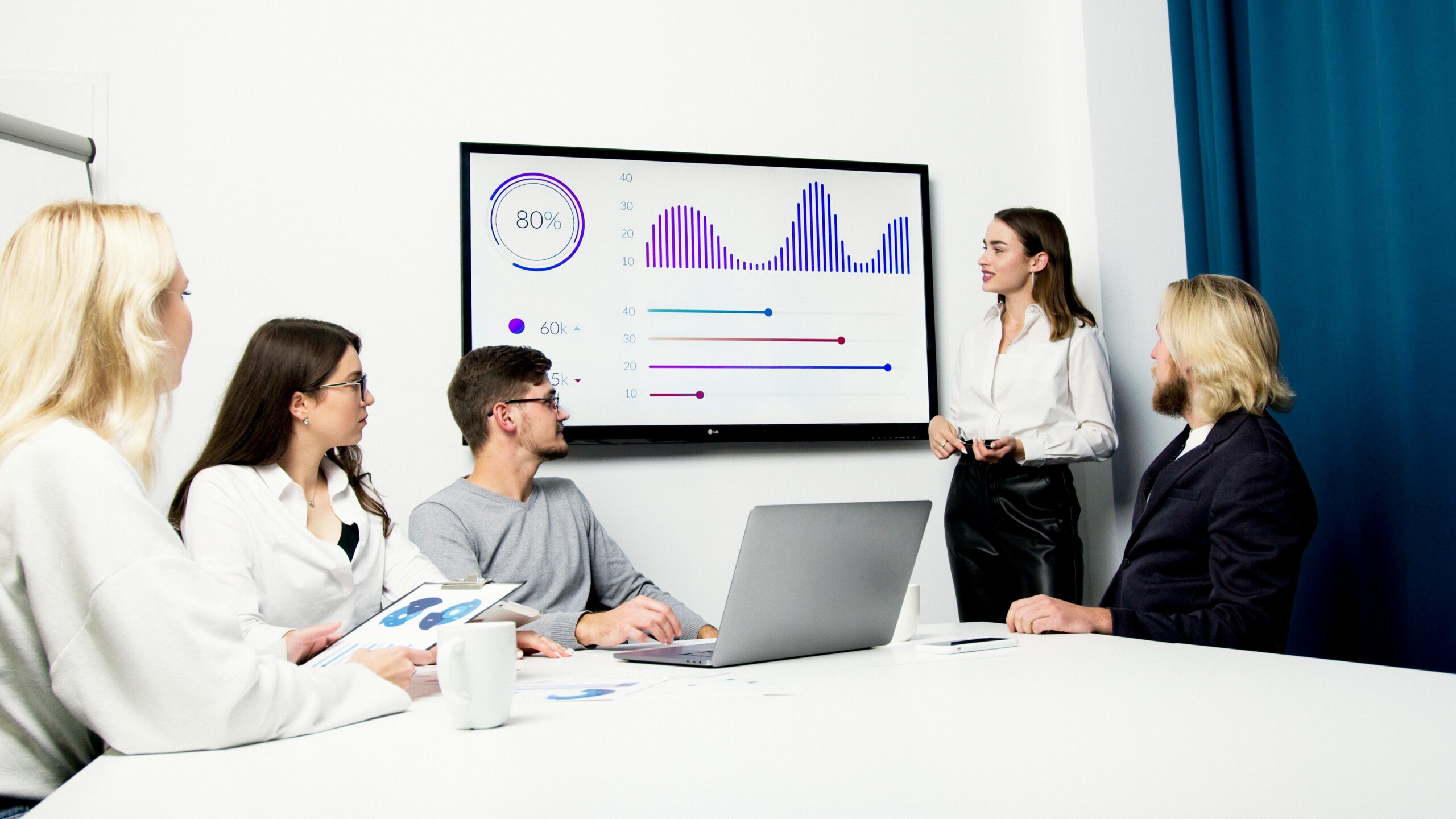 Team meeting for a data presentation. Analysis of charts and statistics for success.