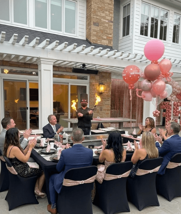 A beautifully plated dish featuring shrimp, colorful vegetables, and garnishes, set in a modern restaurant.