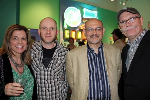 a group photo of three men and a woman