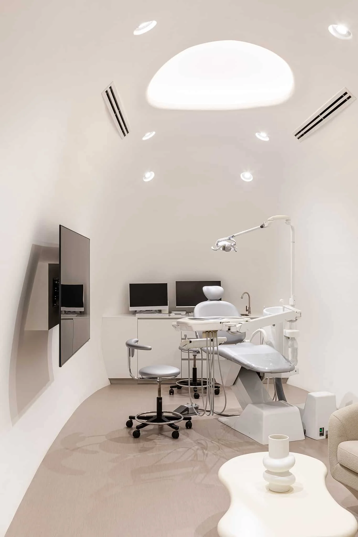 Treatment room with a dental chair and monitor at Siam Square One