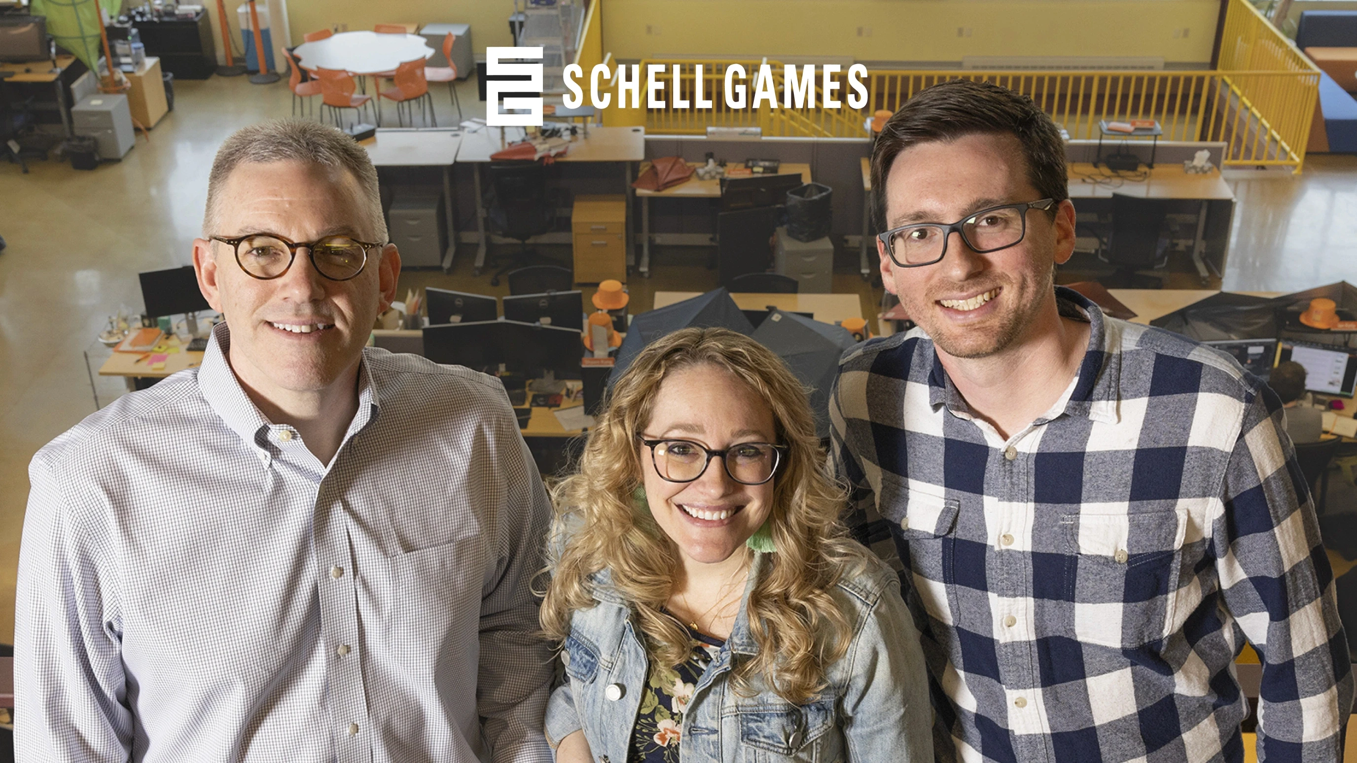 Schell Games board members posing for a picture with their headquarter office in the background