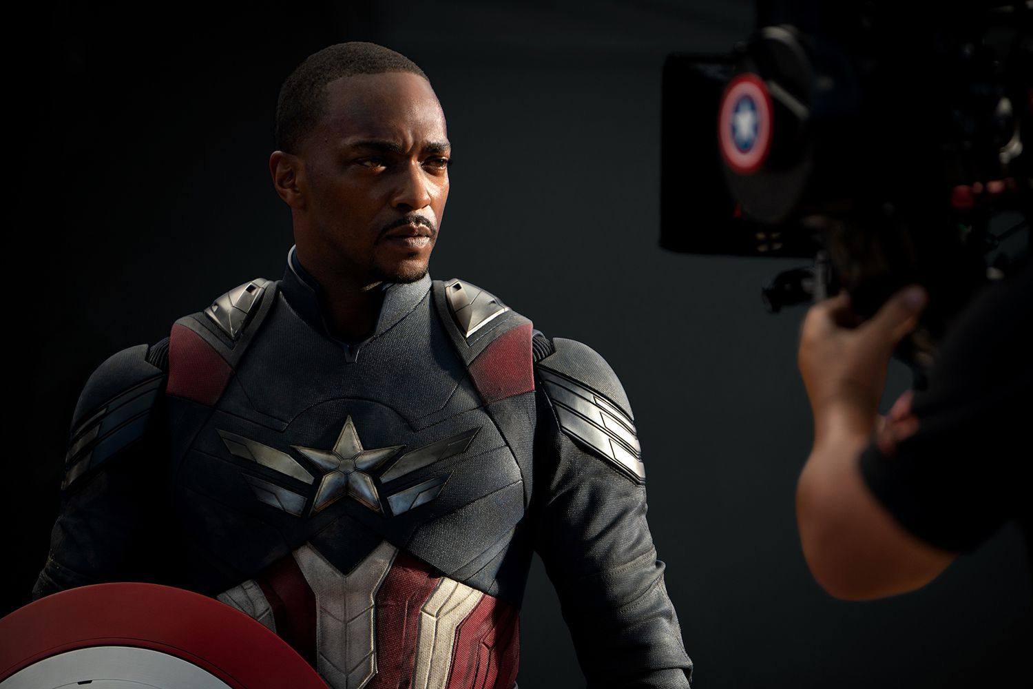 Anthony Mackie as Captain America looks focued in a behind-the-scenes photo from the filming of "Captain America: Brave New World".