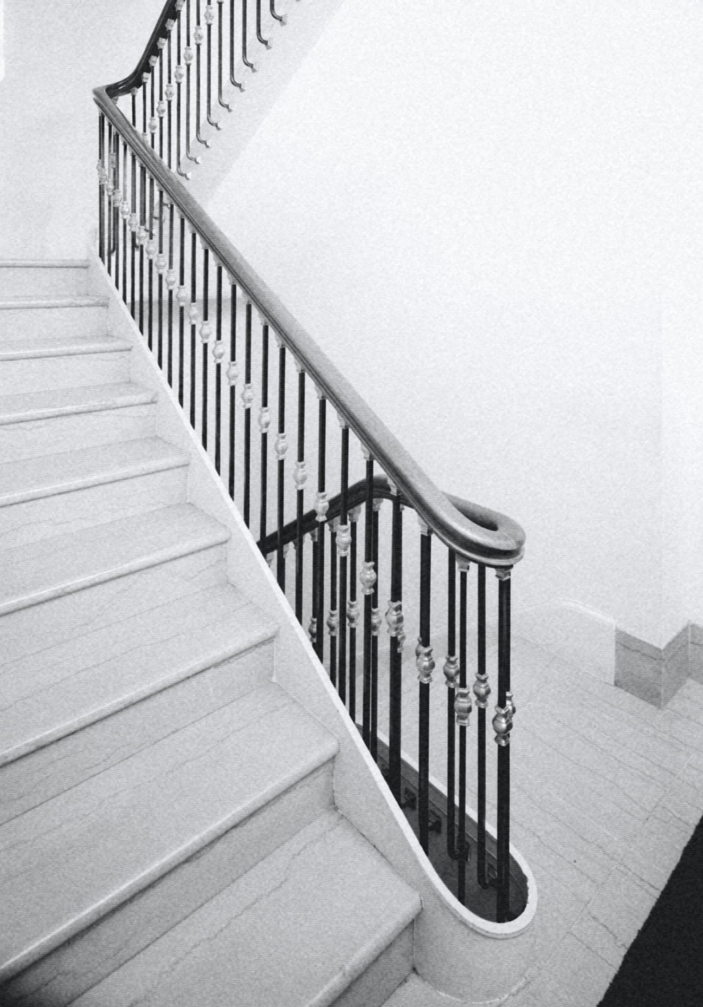 white stair with a black iron railing, black and white