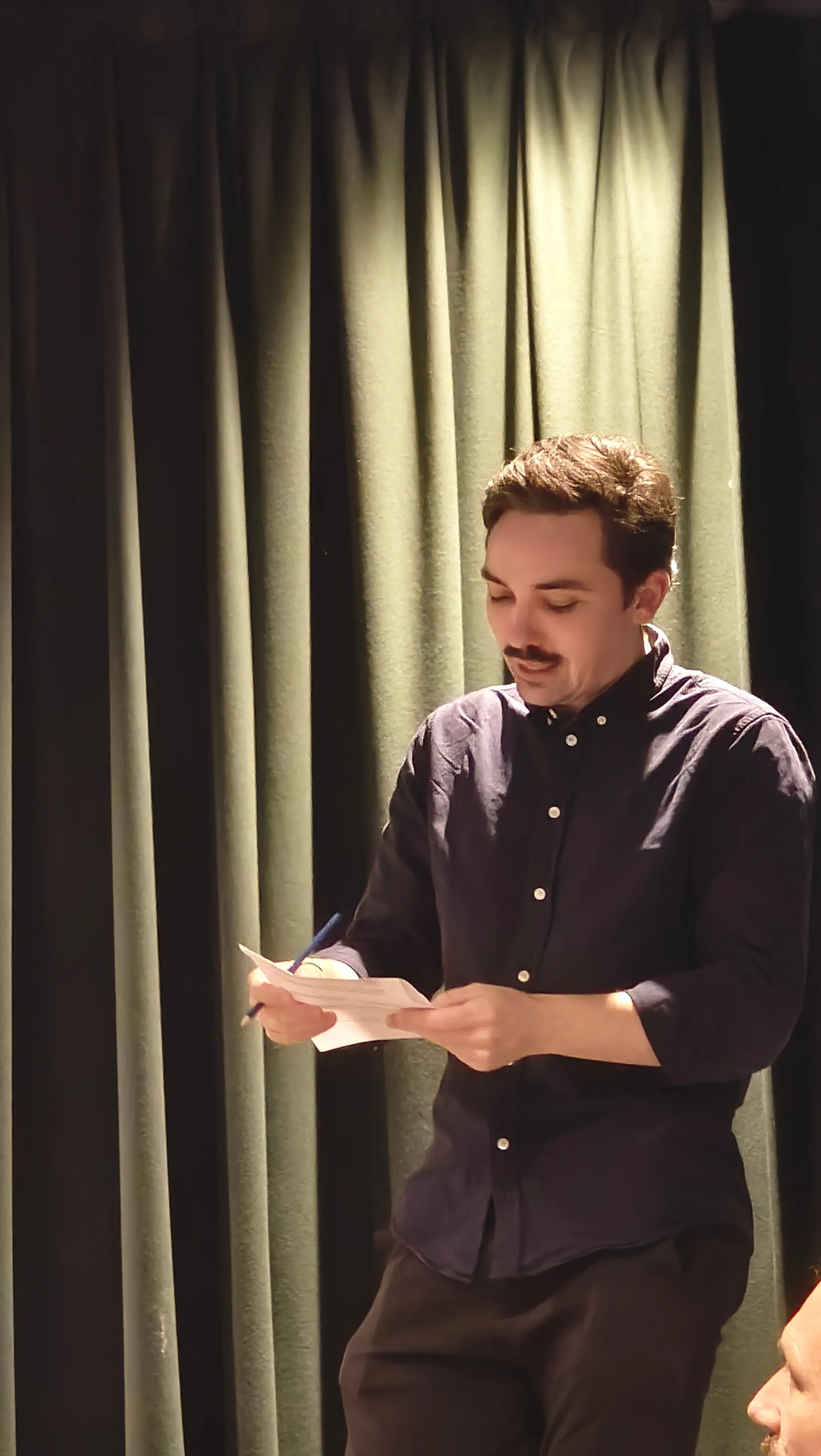 A person talking under a spotlight
