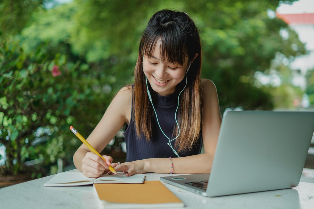 International student preparing for Canadian PR English tests at her desk