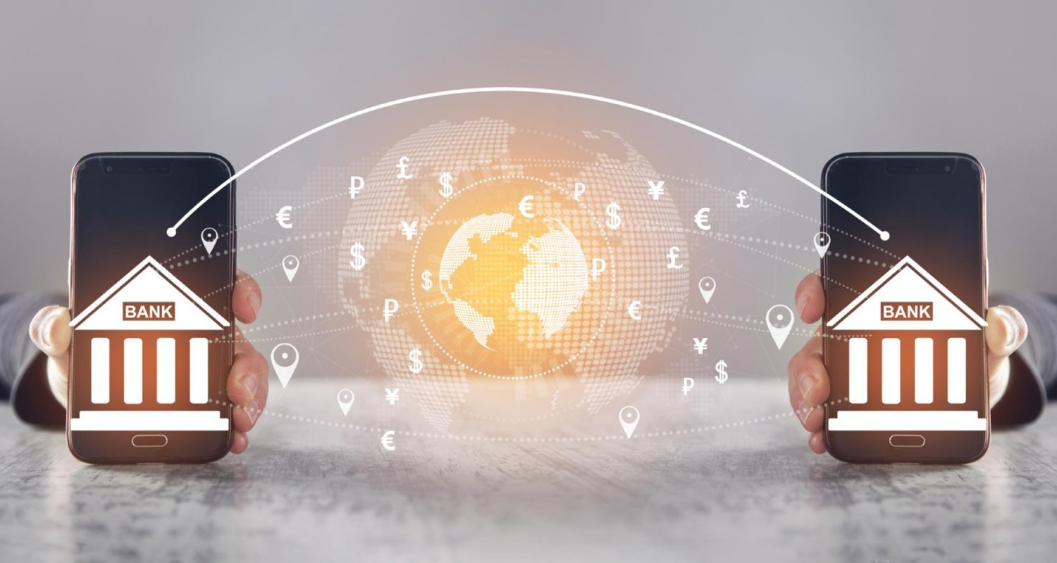 Two hands holding smartphones displaying bank icons, with a glowing digital globe in the center and various international currency symbols connected between the phones, representing global money transfers.