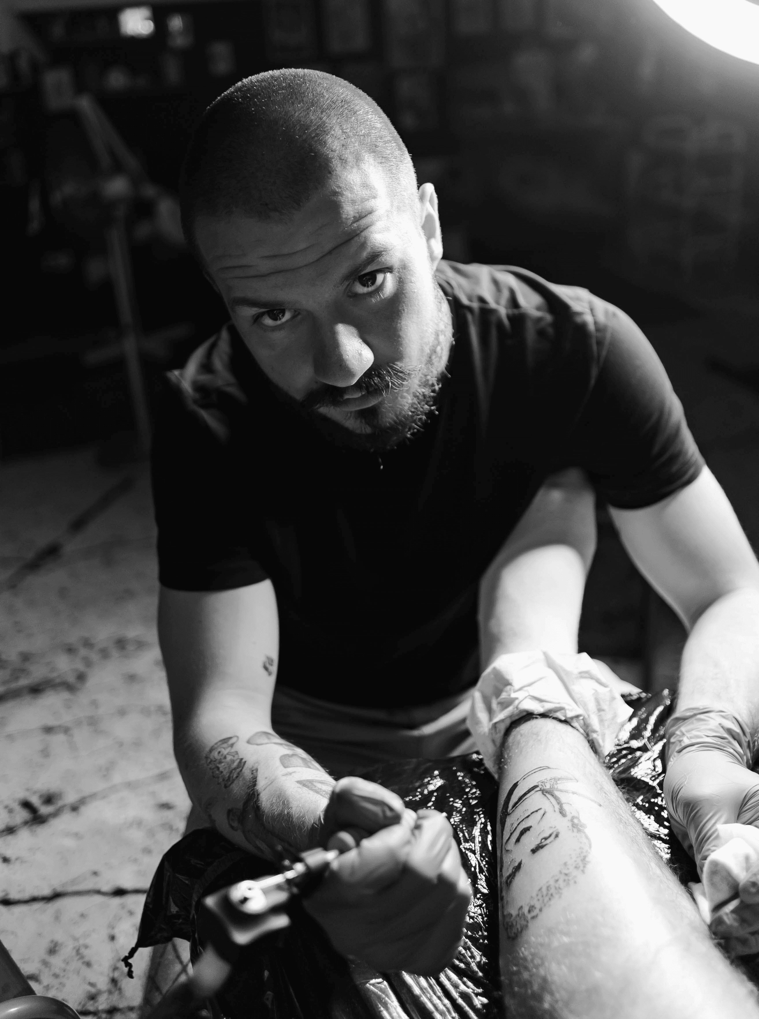 man in black crew neck t-shirt sitting on ground