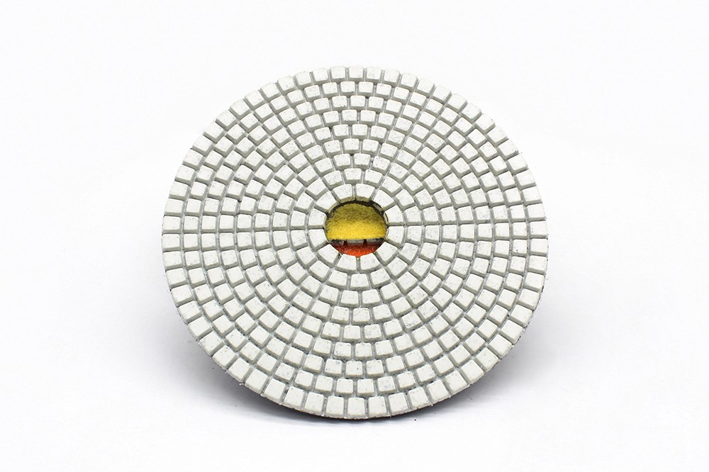 A white resin bond diamond polishing pad with a grid-like pattern, viewed from above.