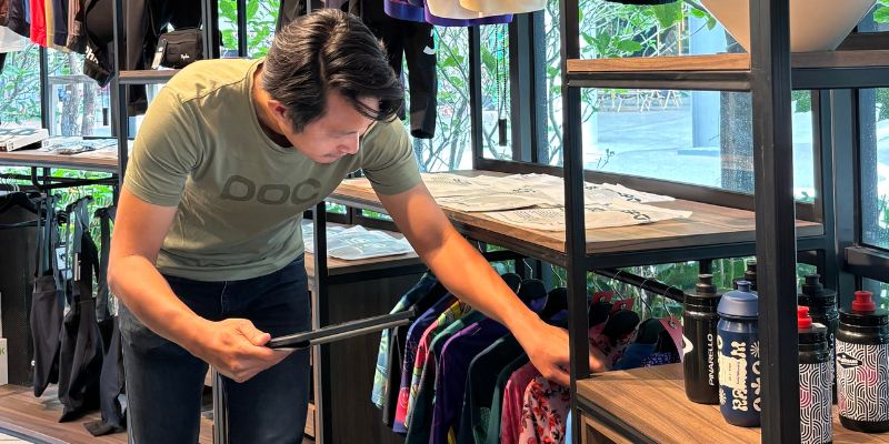 Staff of The Bike Artisans restocking items on the rack.