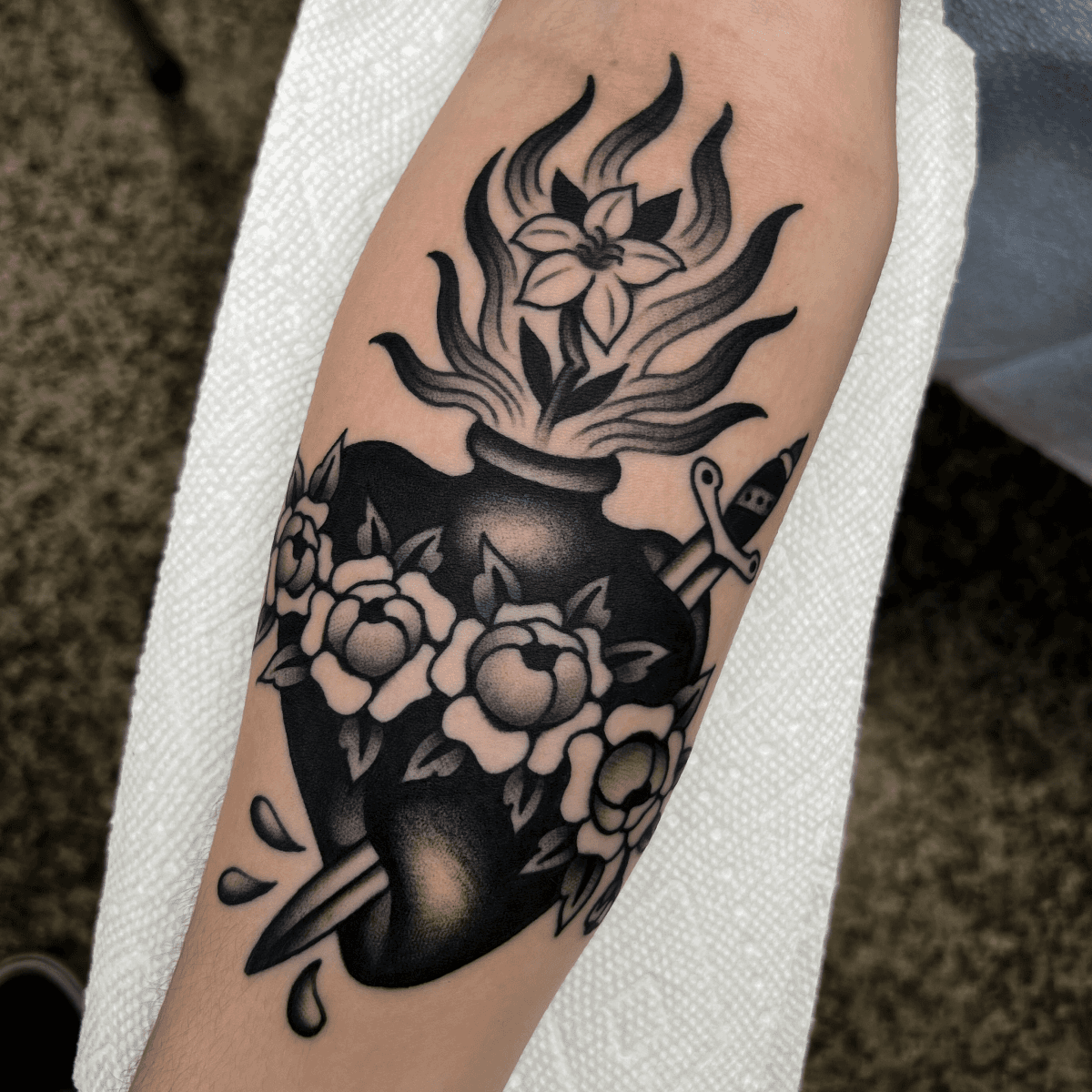 black and gray tattoo of a sacred heart