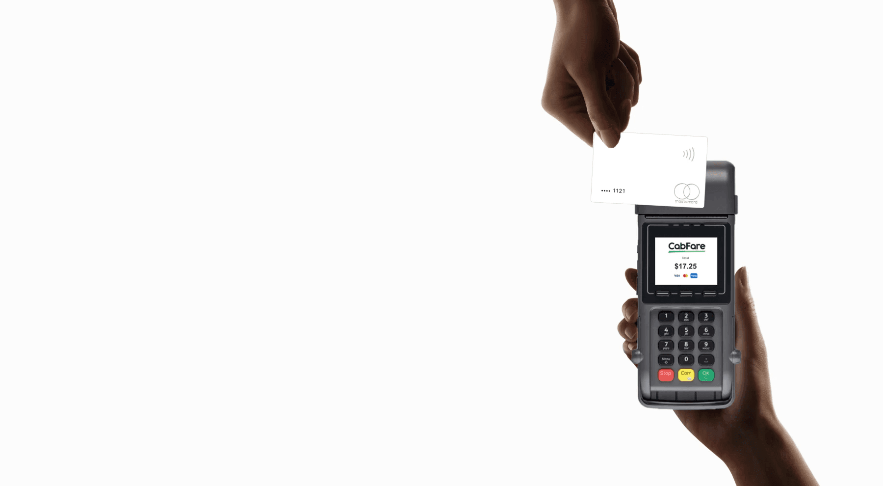 A man driving a car. He is wearing a grey sweater and is looking at the camera with a slight smile.