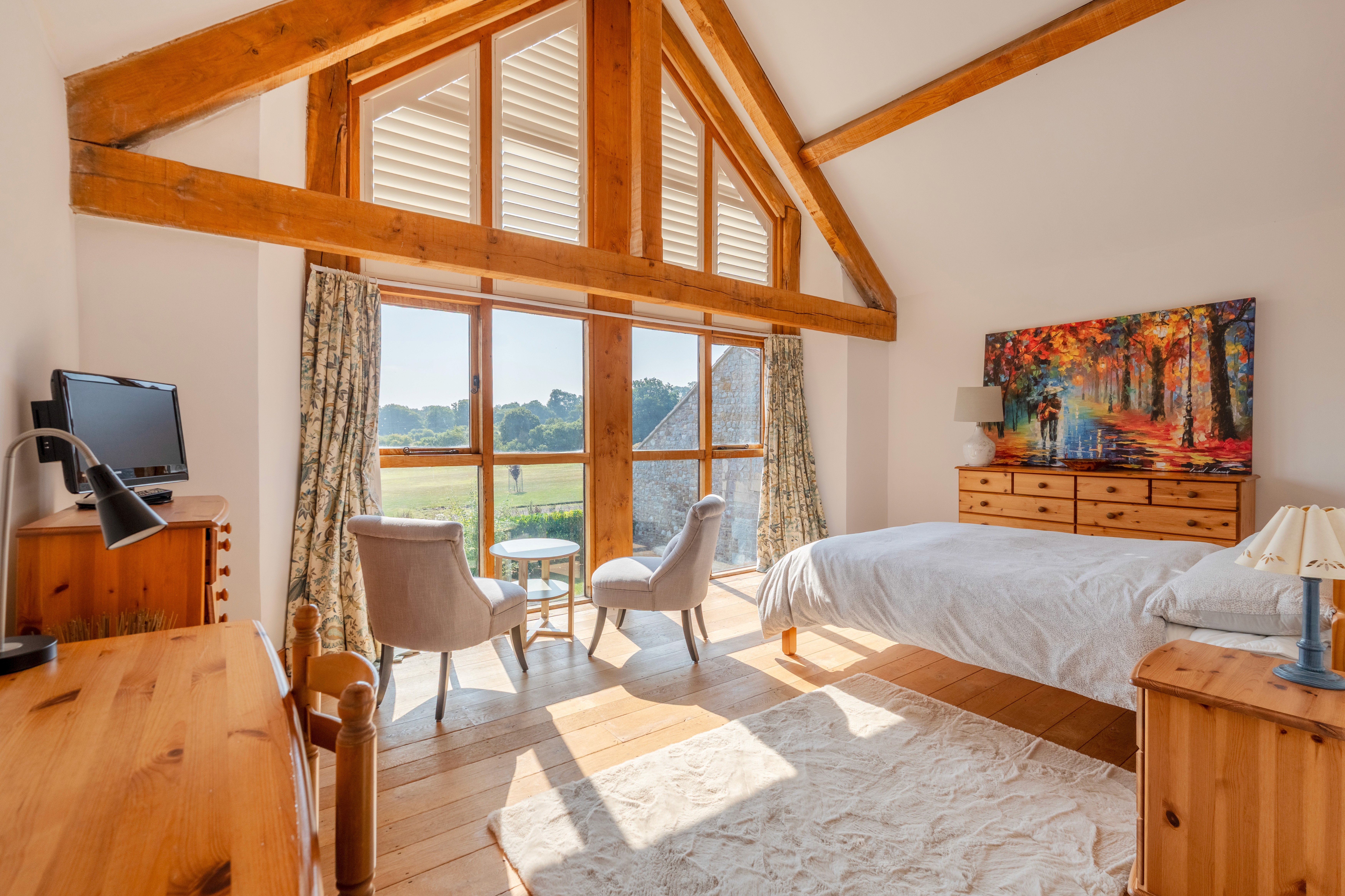 Bedroom with oak beams and countryside views at Meadow Farm