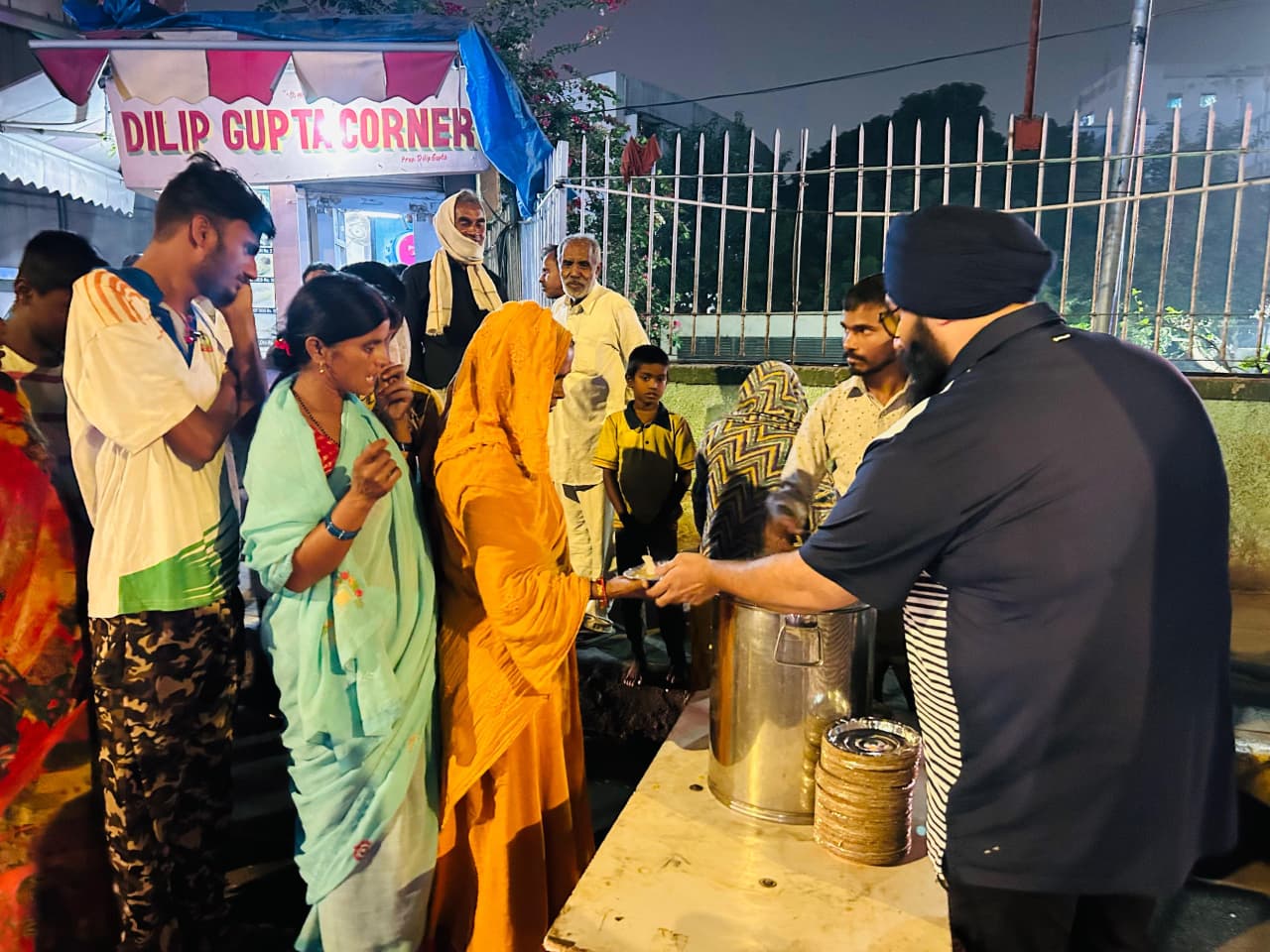 man in black crew neck t-shirt and blue shorts holding woman in white and red