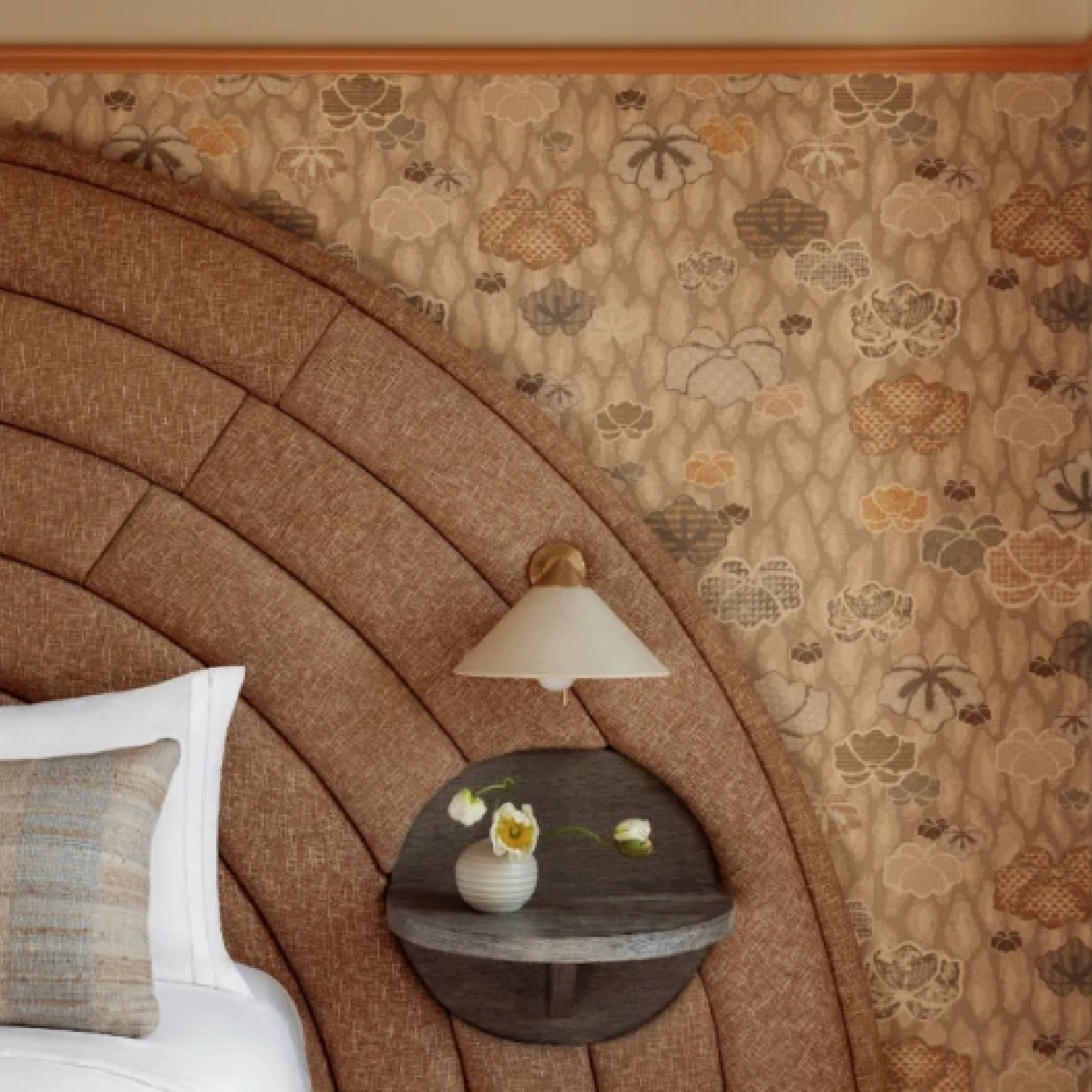 Hotel room bed with printed grass cloth wallcovering on the wall behind it.