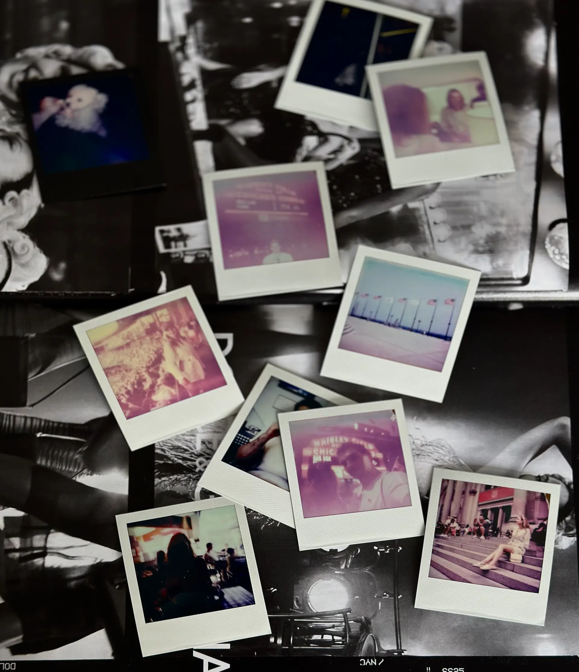 A collection of Polaroid photos scattered on a surface. The images include various scenes such as a person with a dog, a beach with flags, a cityscape with people, and a couple in a brightly lit setting. The Polaroids are placed over a collage of black-and-white photographs.
