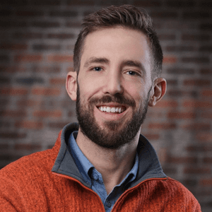 Young woman running through a grassy field